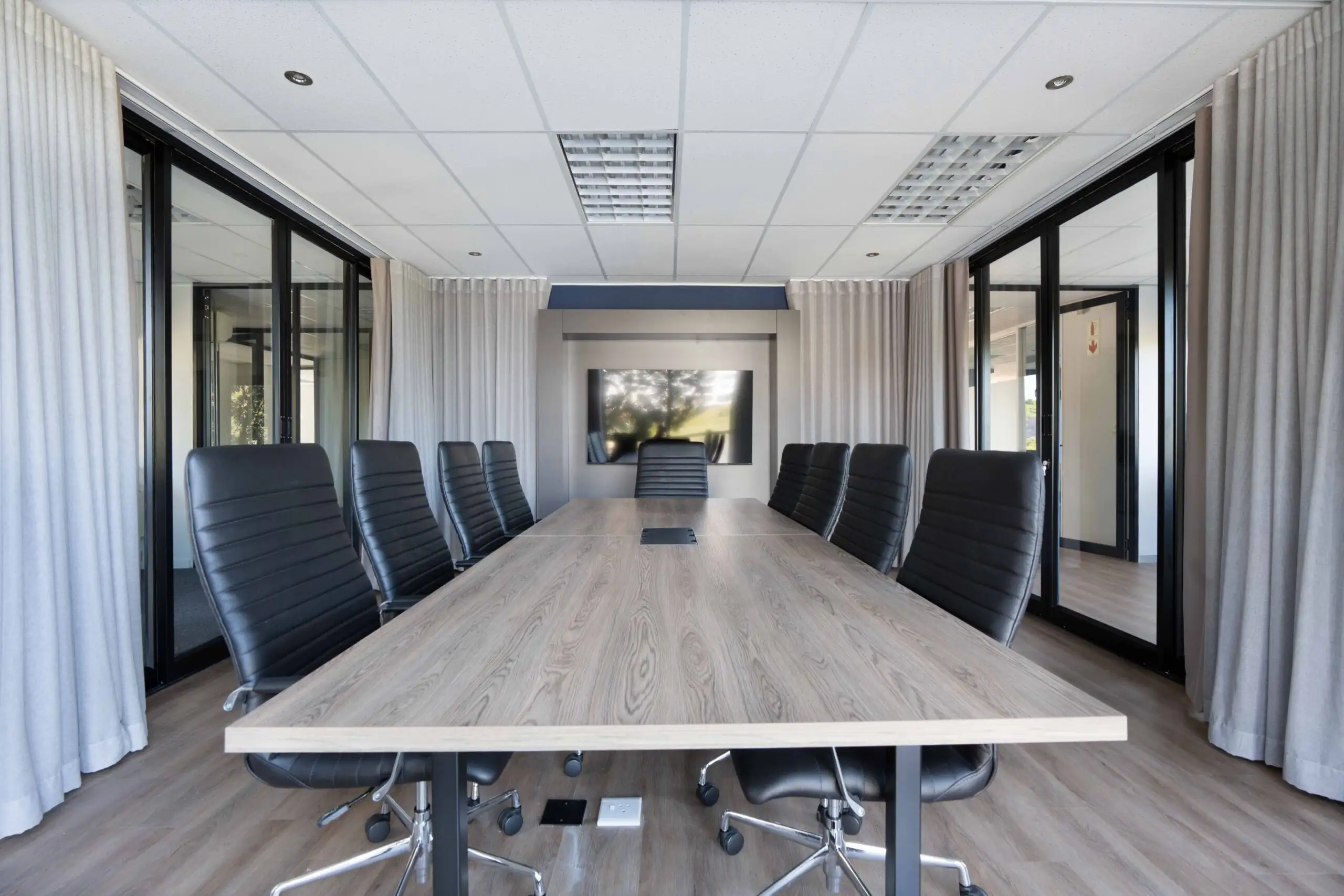 Completed office fit out with glass partitioned meeting rooms and workstations
